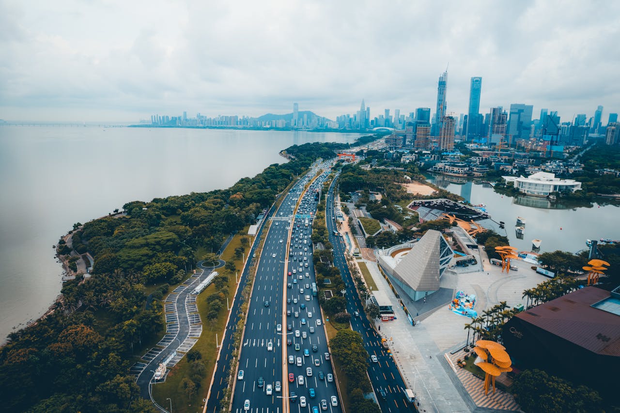 Stunning aerial view of a bustling highway and urban skyline in Shenzhen, China.