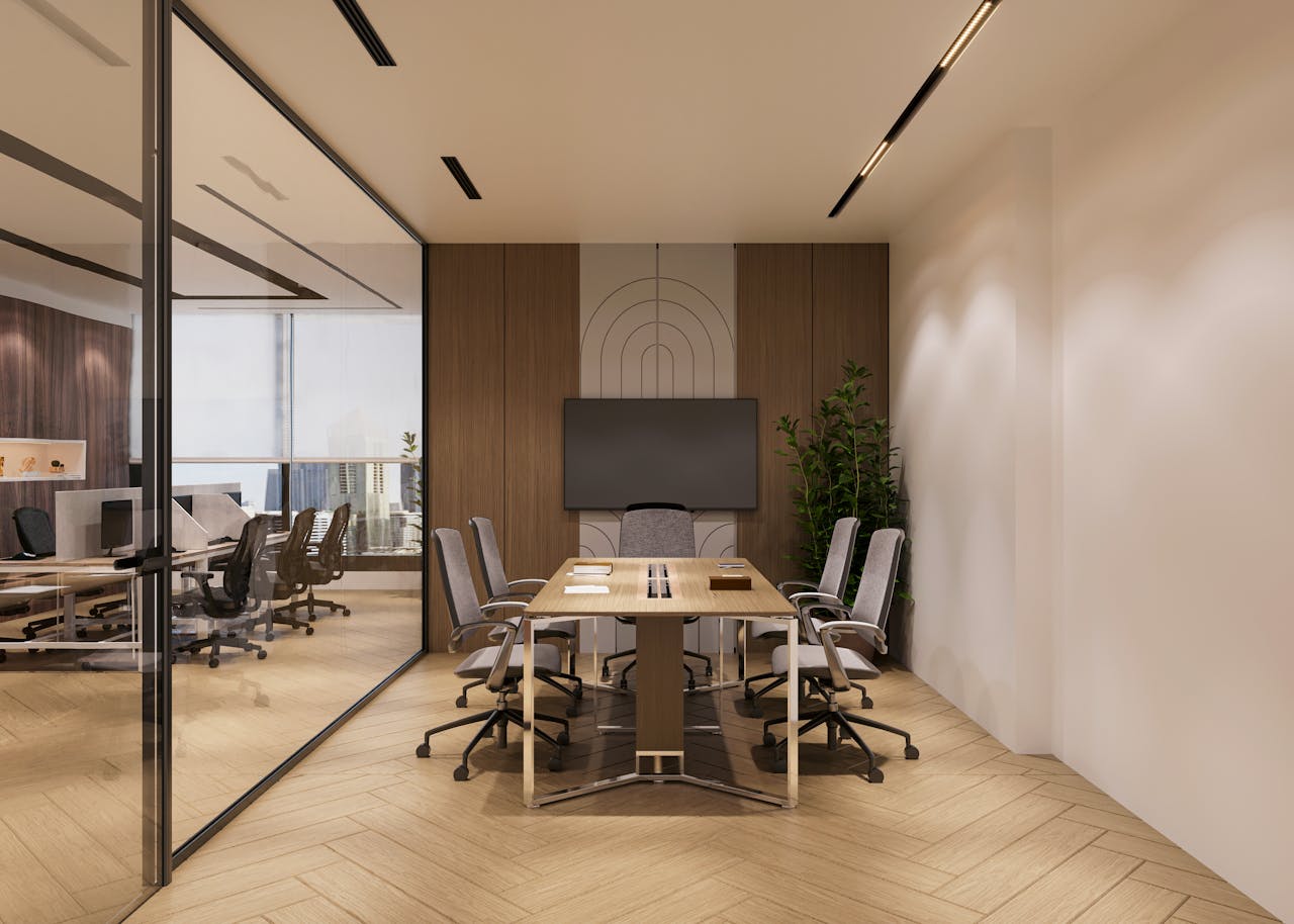 A sleek, modern conference room with a large screen, wooden accents, and a view of the city skyline.